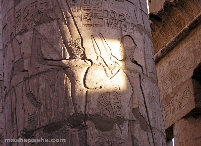 Ancient Egyptian drawings and reliefs are preserved on the walls and columns. — Karnak Temple, Luxor, Egypt