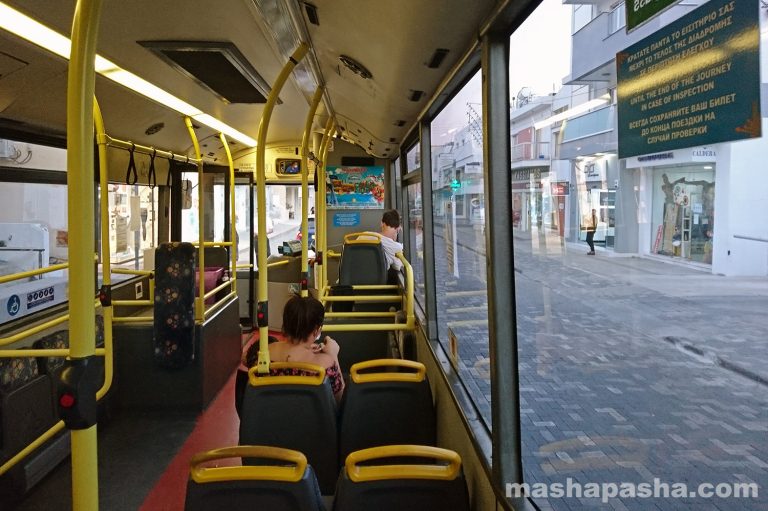 A bus of route 101 stands at the terminal stop in the centre of Paralimni — Paralimni city center, Cyprus